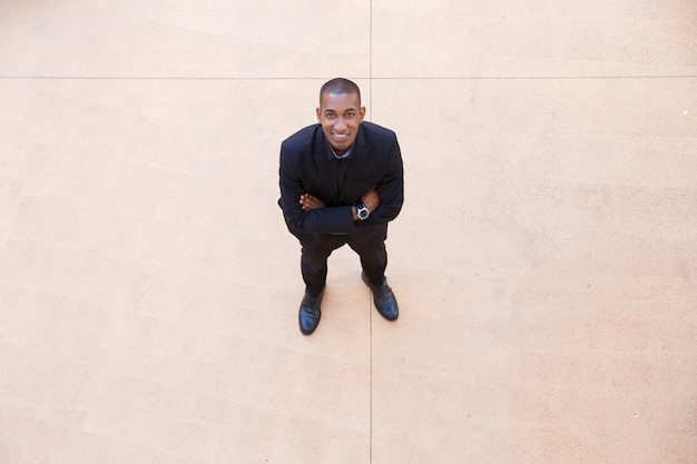 Happy confident businessman posing in office lobby