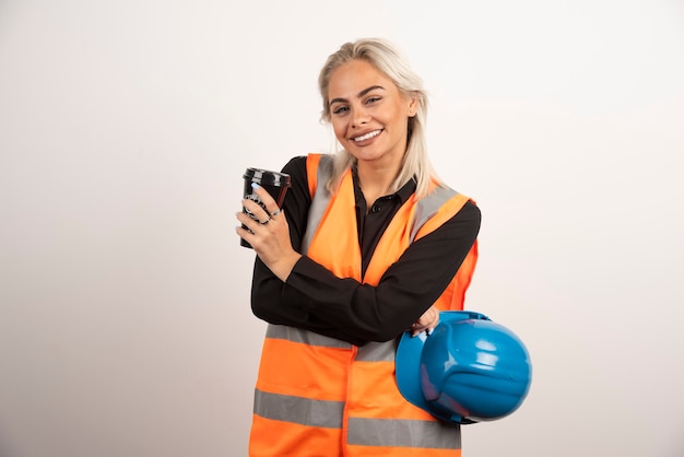 Happy construction worker having break with cup of tea. High quality photo