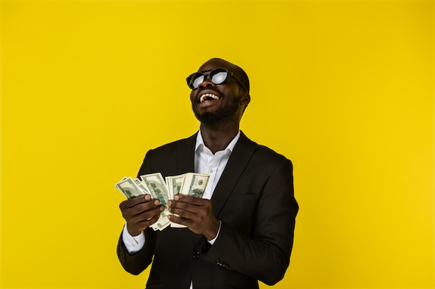 Happy cool man enjoys the money