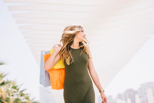 Happy cool woman posing during shopping