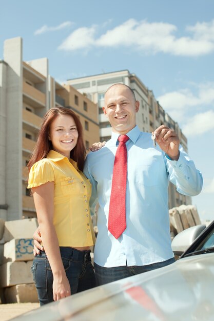 happy couple against real estate