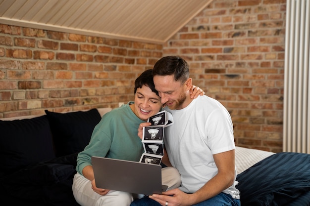 Happy couple announcing pregnancy over a videocall