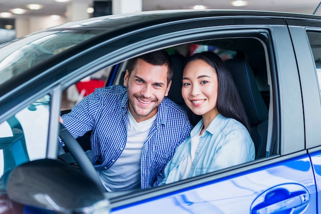 Happy couple at car dealership