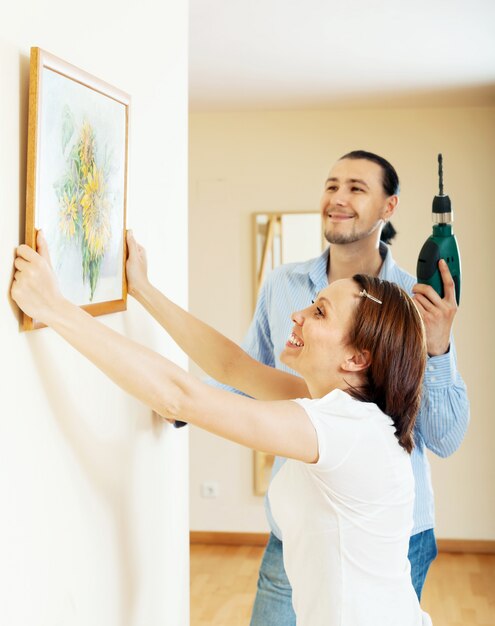 Happy  couple choosing place for picture in frame