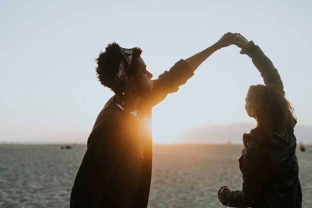 Happy couple dancing at the beach