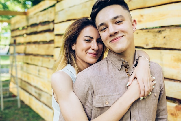 Happy couple embracing at fence