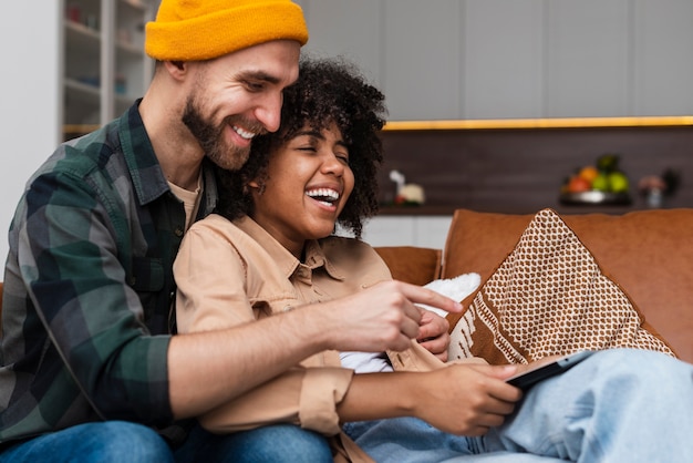 Happy couple embracing on sofa