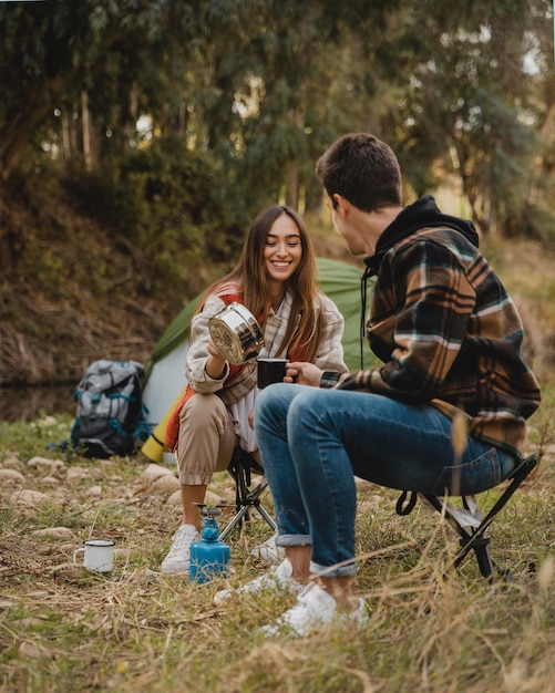 Free photo happy couple in the forest being together at camping