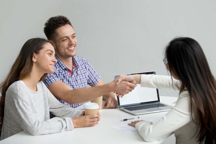 Free Photo happy couple greeting financial consultant