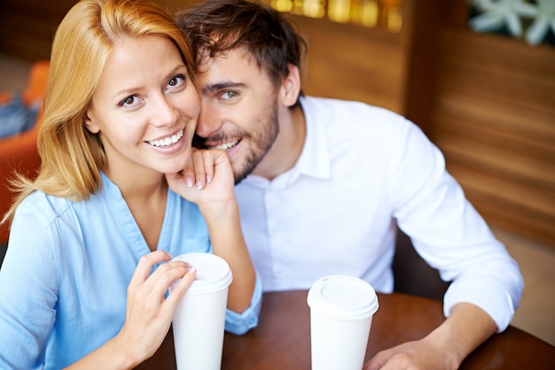 Happy couple having fun in coffee shop