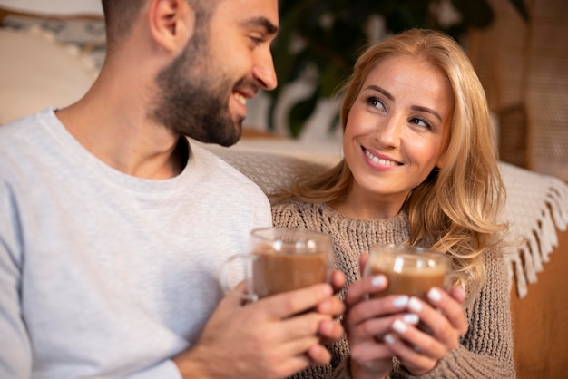 Free photo happy couple holding drinks