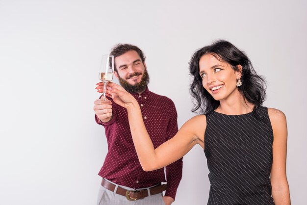 Free photo happy couple holding glass of champagne