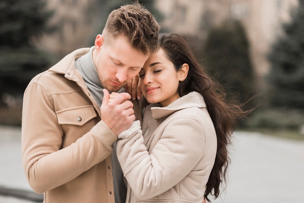 Free photo happy couple holding hands outside