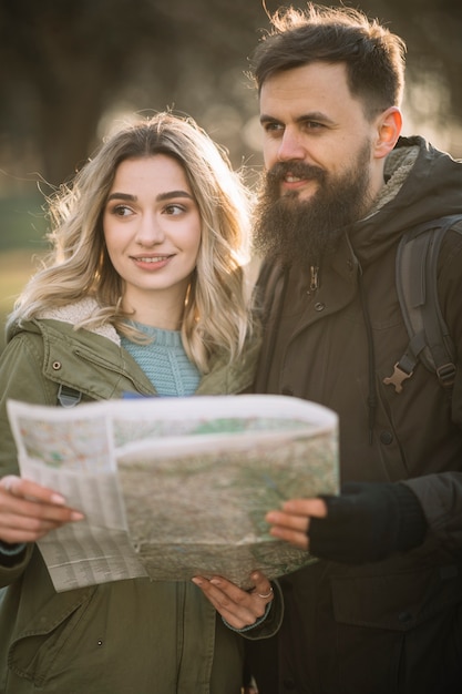 Free photo happy couple holding map