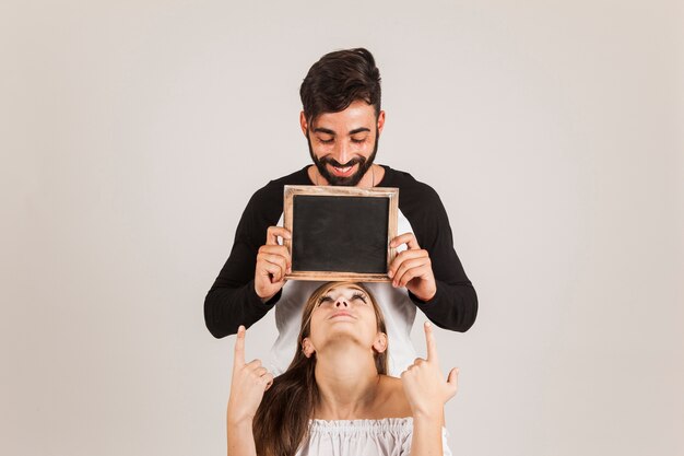 Happy couple holding slate