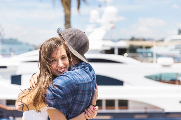 Happy couple hugging on seafront