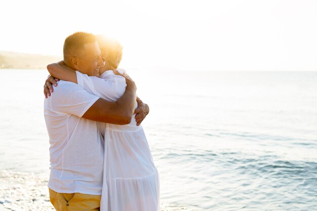 Happy couple hugging at seaside