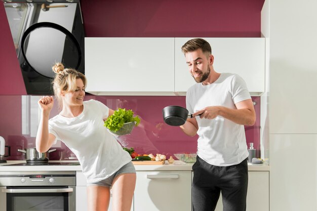 Happy couple indoors cooking