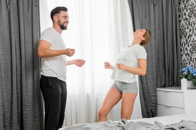 Happy couple indoors dancing