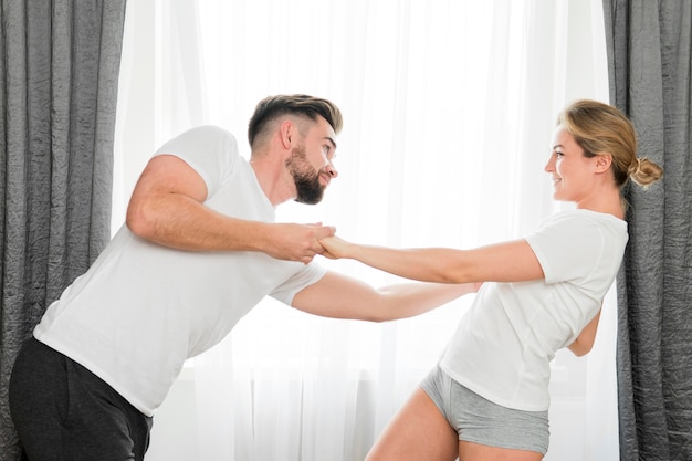 Happy couple indoors holding hands