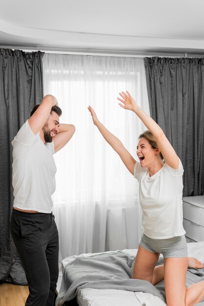 Happy couple indoors playing together