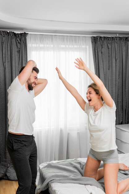 happy couple indoors playing together