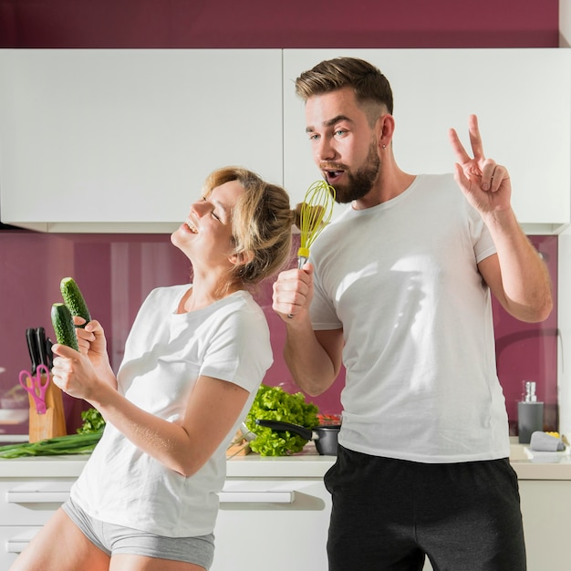 Happy couple indoors singing and dancing