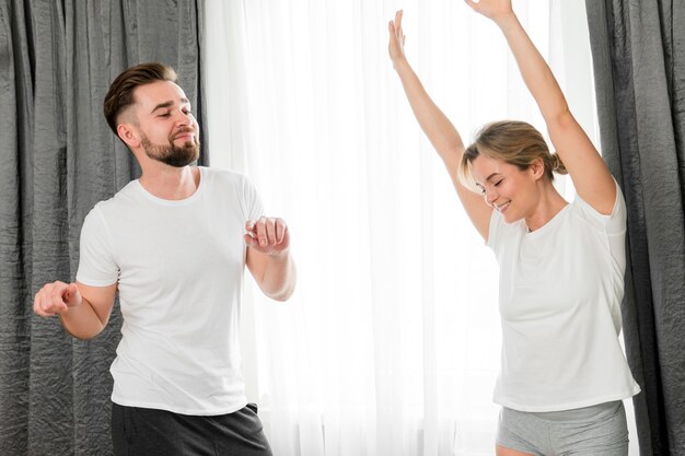 Happy couple indoors wearing white clothes