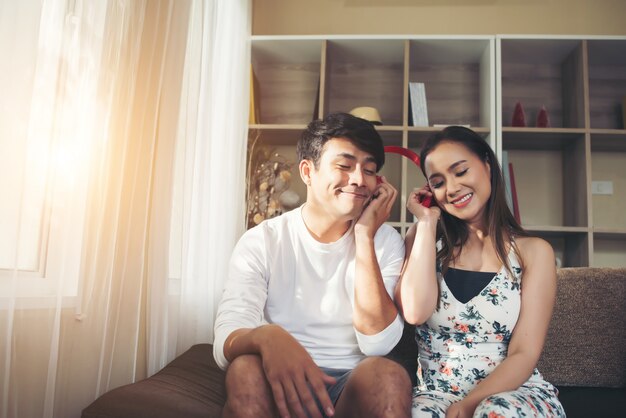 Happy couple is relaxing and playing together the living room.