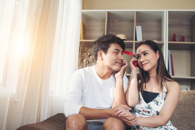 Happy couple is relaxing and playing together the living room.