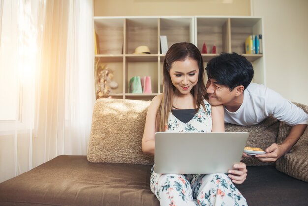 Happy couple is relaxing and playing together the living room.