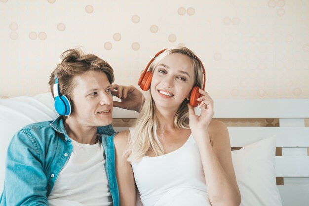 Happy couple listening song in the morning at bedroom