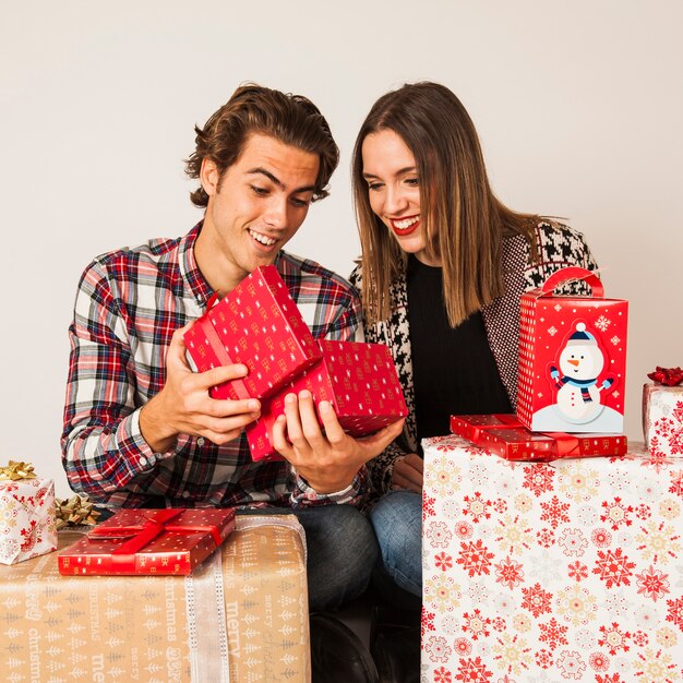 Happy couple looking into present boxes