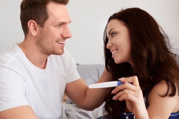 Happy couple looking at pregnancy test