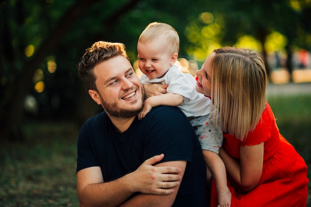 Happy couple looking at their child