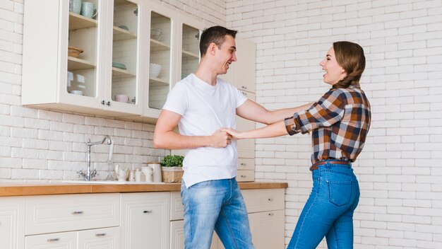 Happy couple in love playing in kitchen