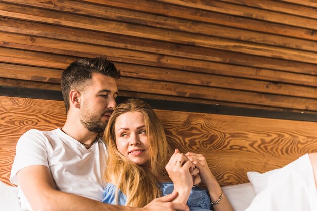 Happy couple lying on bed