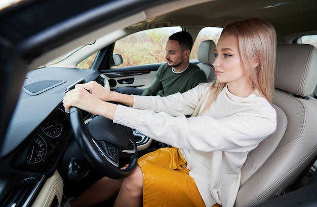 Happy couple man and woman traveling in car