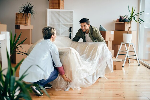 Happy couple moving into their new apartment