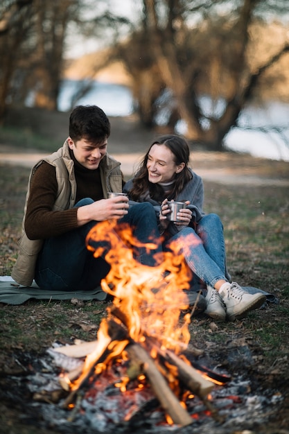 Happy couple near campfire