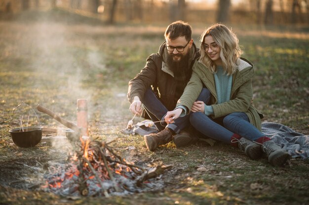 Happy couple near campfire