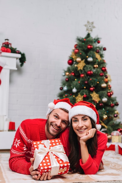 Happy couple near Christmas tree