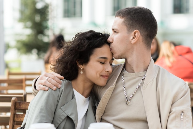 A happy couple outdoors near a cafe