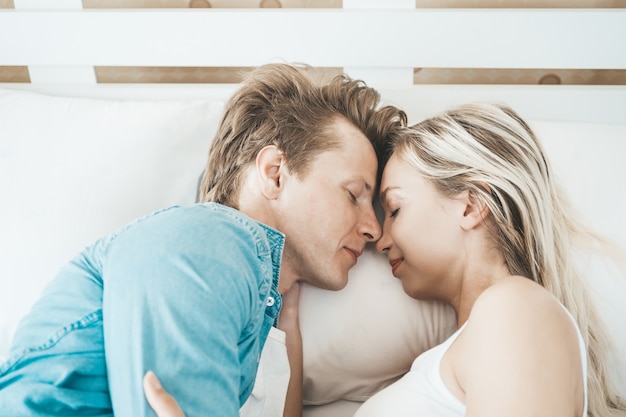 Happy Couple Playing together in the bedroom