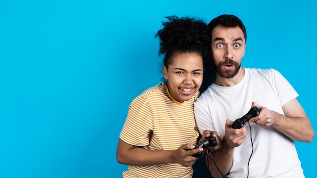 Happy couple playing with game controllers