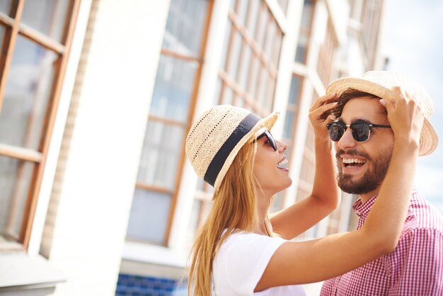 Happy couple playing with the hats