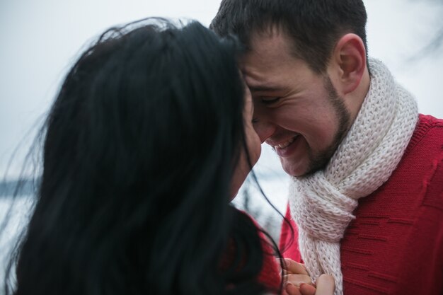 "Happy couple in red sweaters"