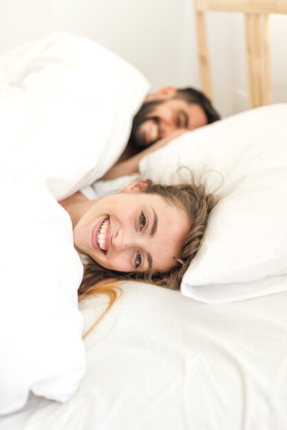 Happy couple relaxing on bed