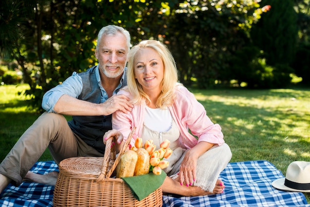 Happy couple sitting on a blanket