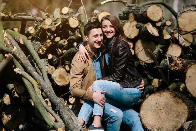 Happy couple sitting on logs